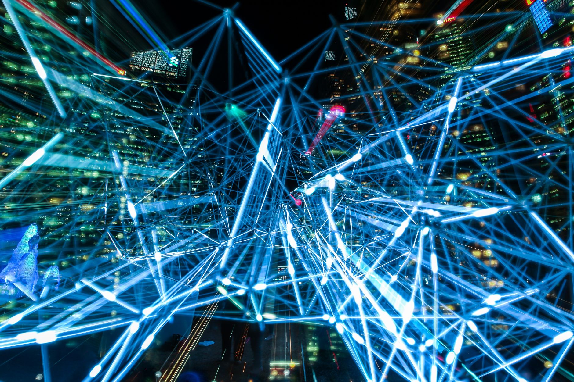 Dynamic urban scene showcasing interconnected light trails representing digital communication networks. — Embedded Analytics