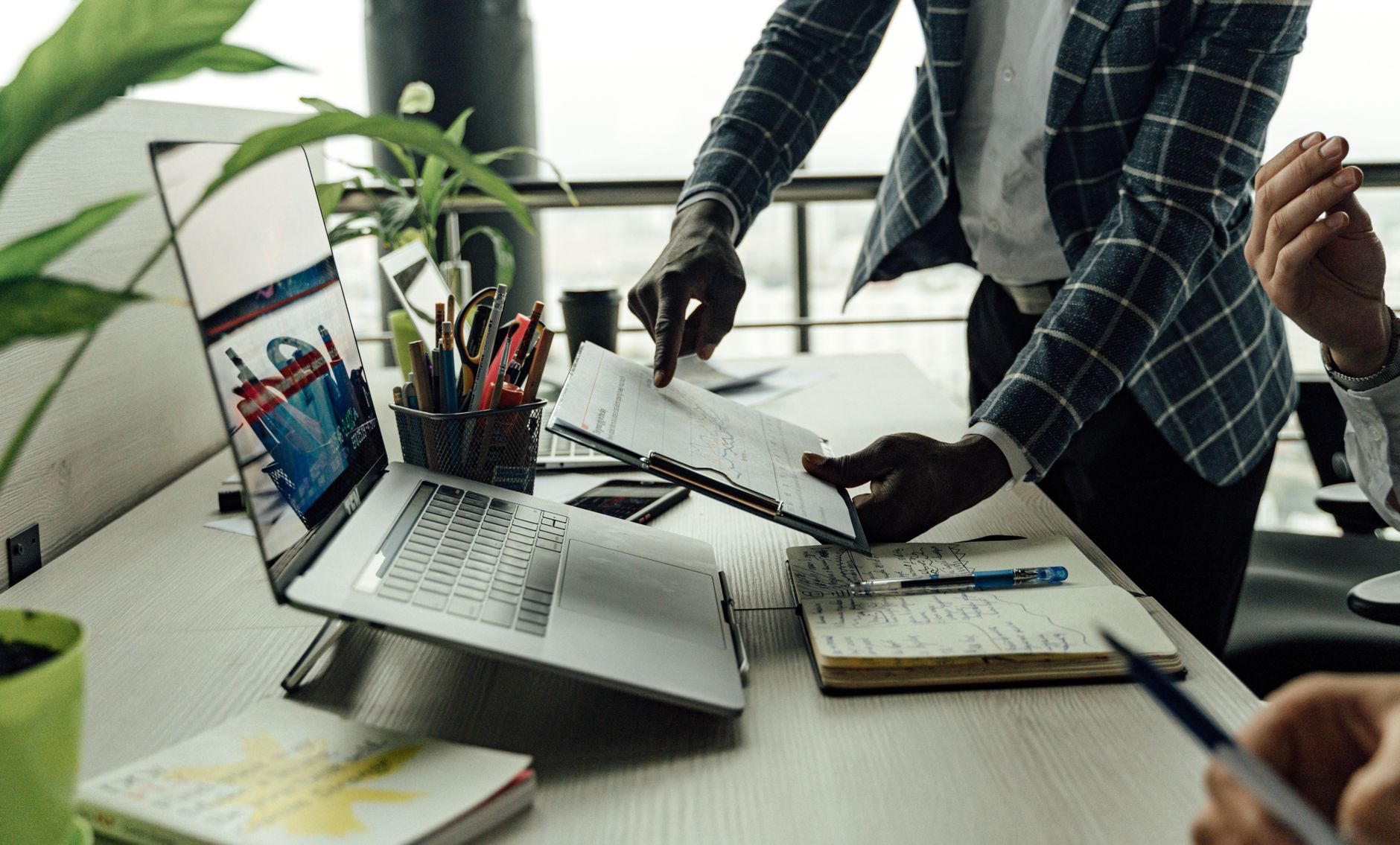 Colleagues collaborating on financial data analysis with a laptop in the office. — Top Features to Look for in Construction S