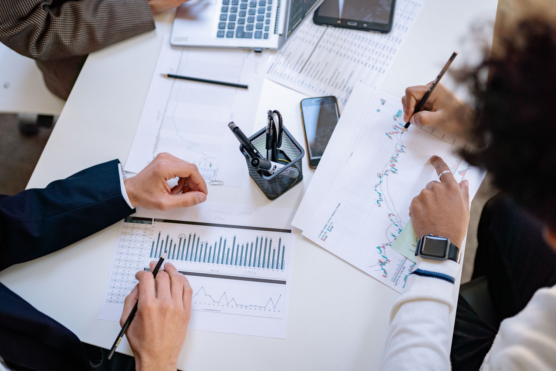 Business team analyzing financial charts and graphs during a collaborative meeting. — Travertine tiles for sale supporting co